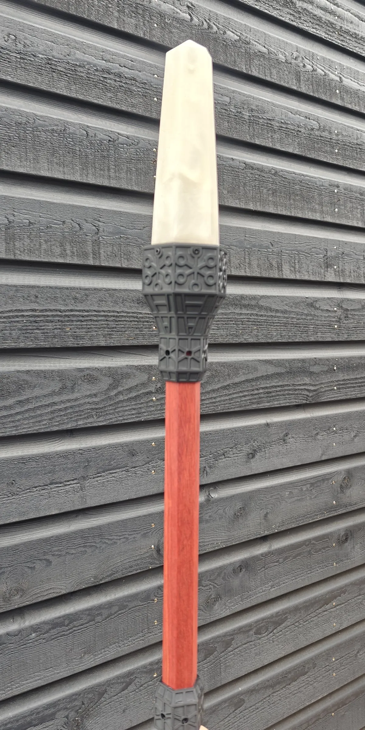 Pale pointed crystal in a black Art Deco topper on a red wooden shaft