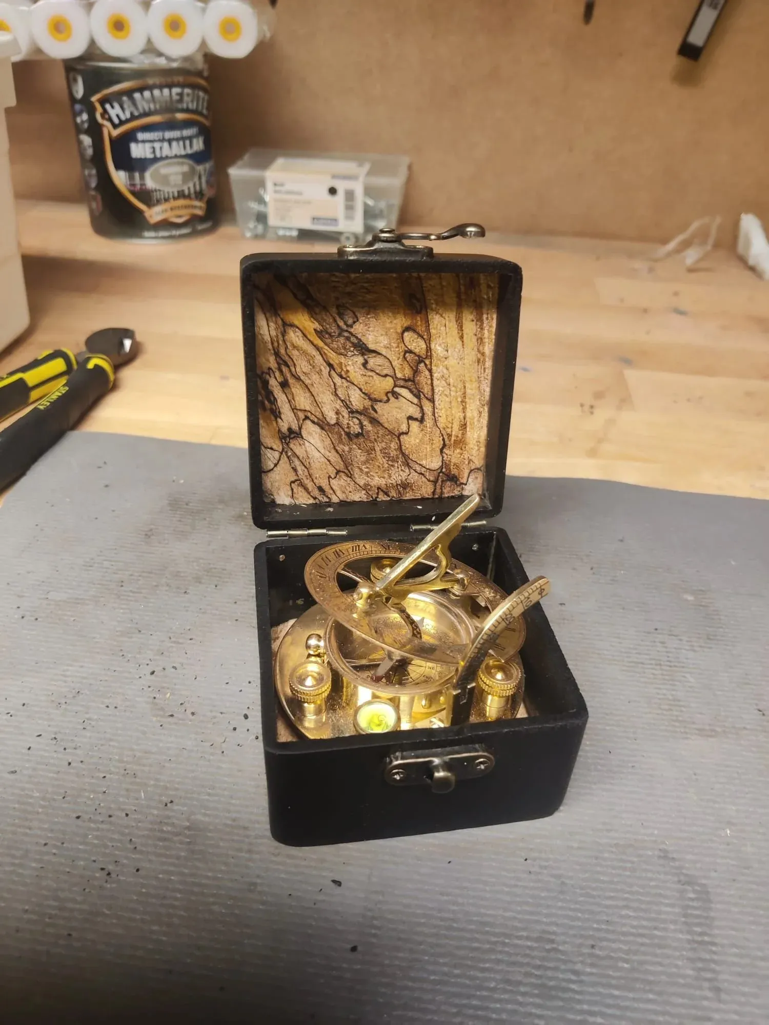 Open black box with a spalted maple lid, holding a brass compass