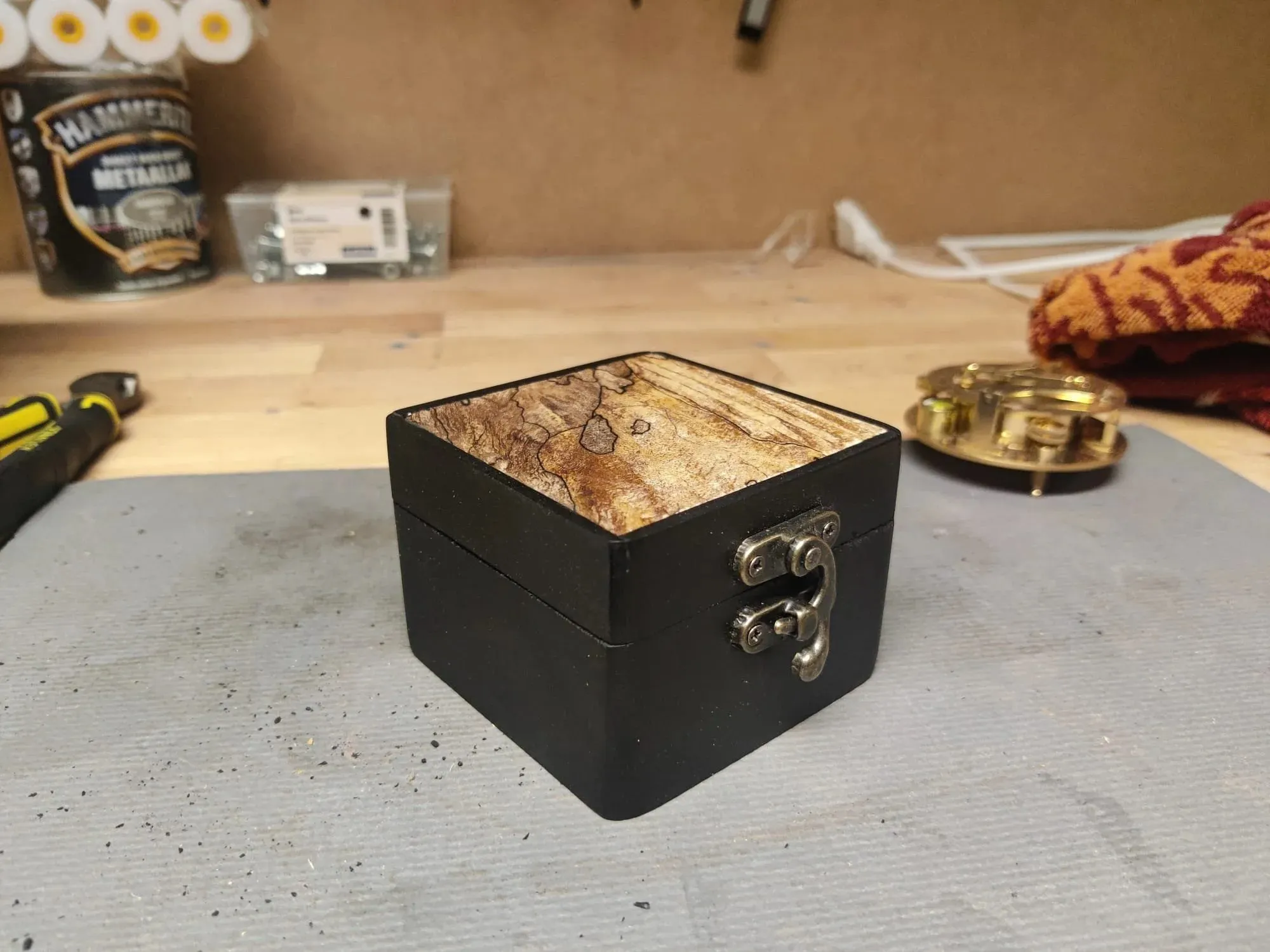 The box closed, showing the spalted maple top and a brass clasp