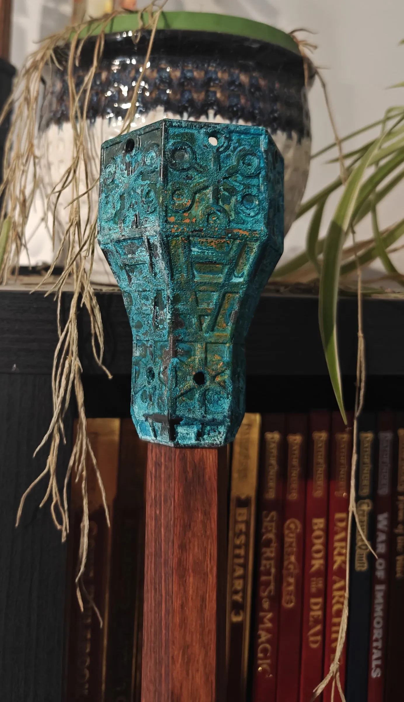 Art Deco topper covered in a green-blue copper patina