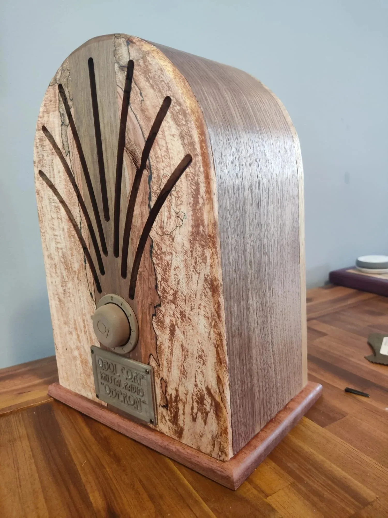 The radio from an angle, showing the curved walnut side