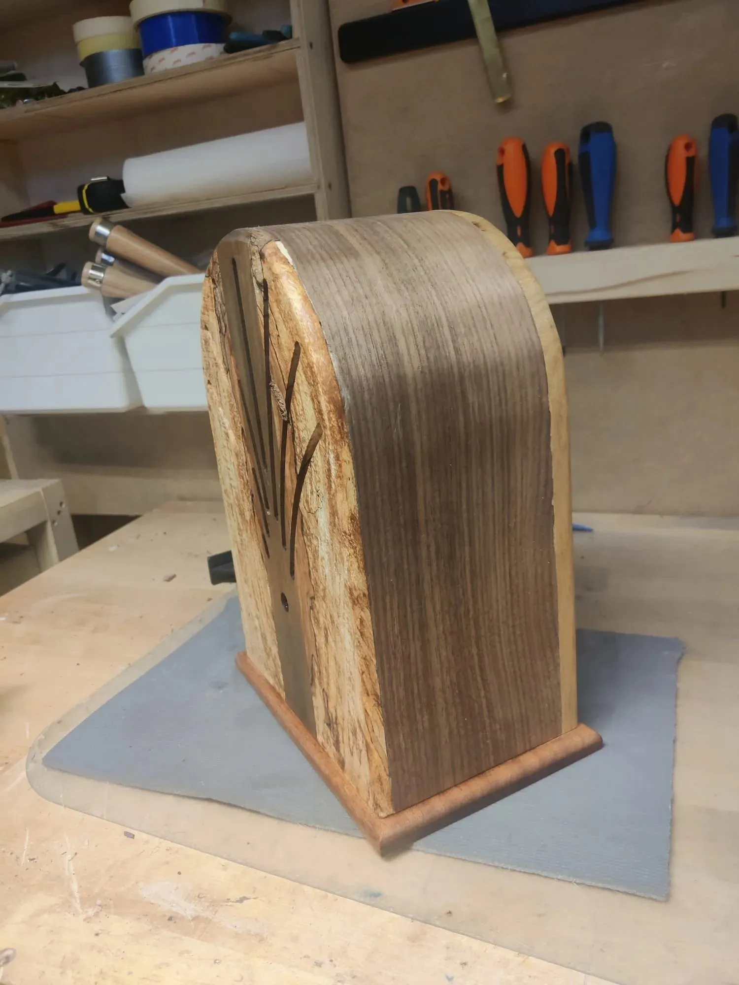 Side view in the workshop showing the curved walnut veneer