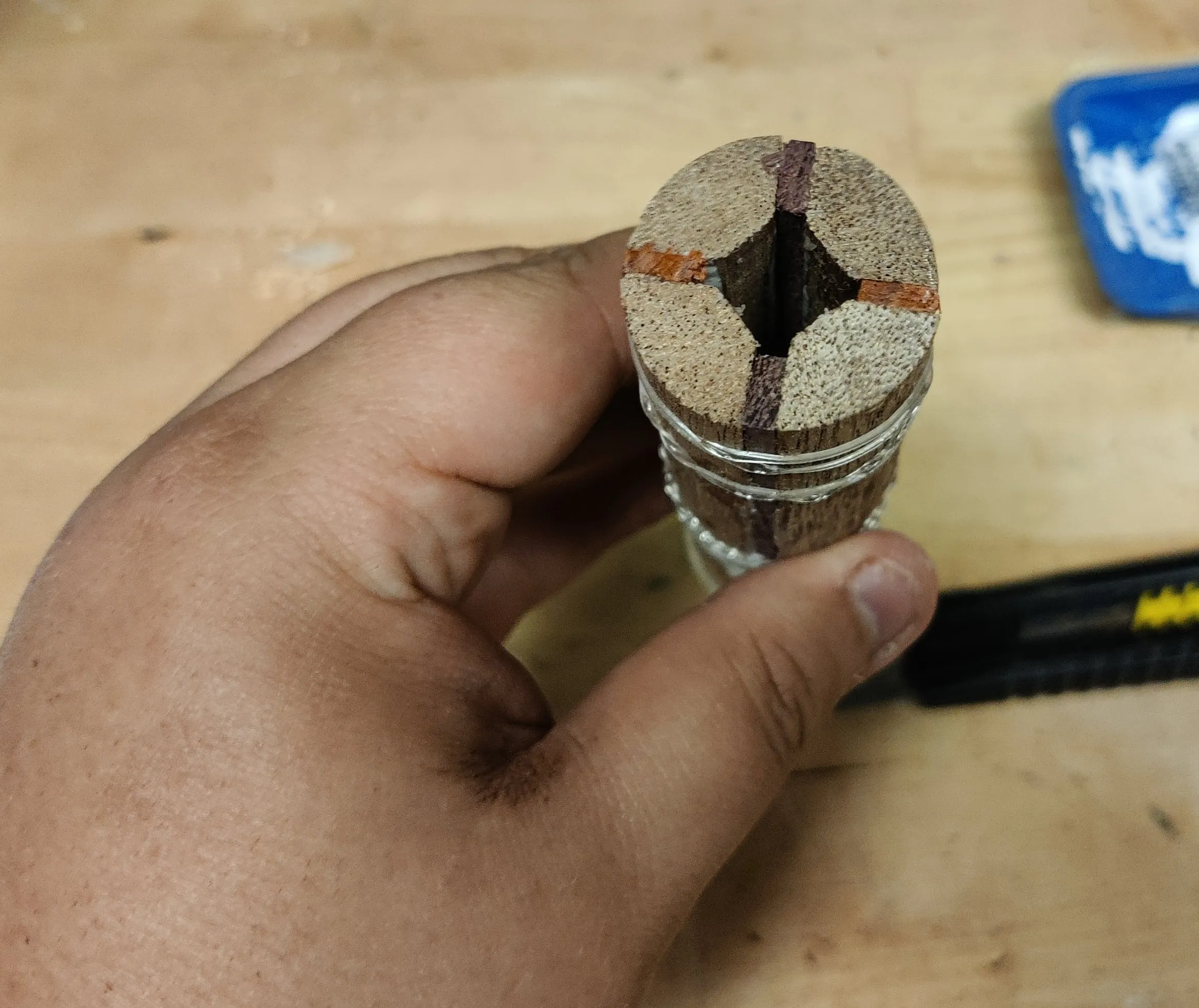 The end of a glued-up wooden shaft with a channel through the middle