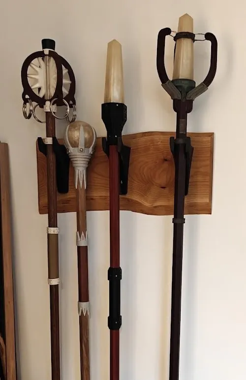 Four staves hanging on a live-edge wooden wall mount